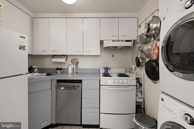 a kitchen with a white cabinets and white appliances