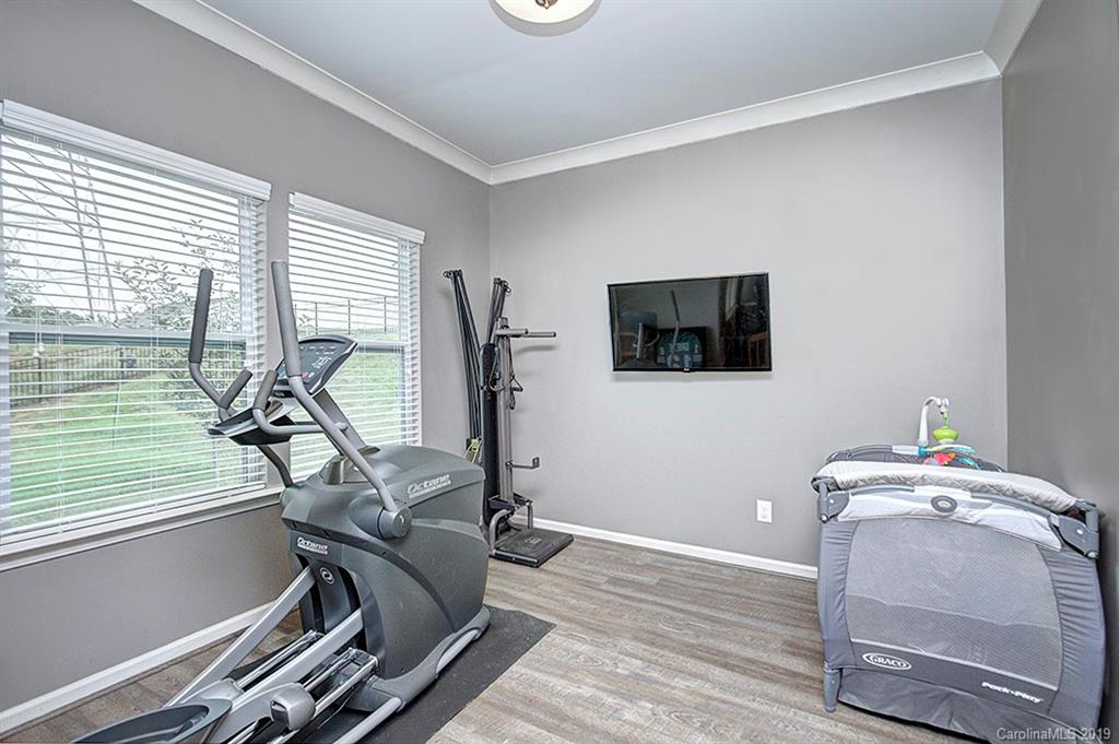 8008 Bryson Road Indian Land, SC 29707 - Photo 18 of 22 a room with gym equipment and a flat screen tv