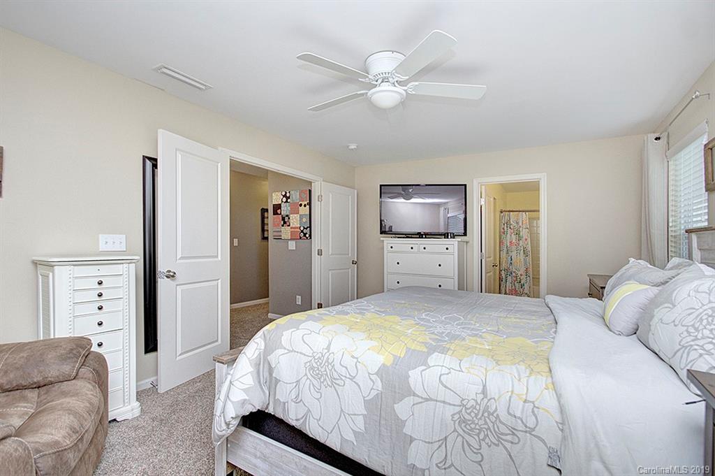 8008 Bryson Road Indian Land, SC 29707 - Photo 19 of 22 a bedroom with a large bed a flat tv screen and dresser