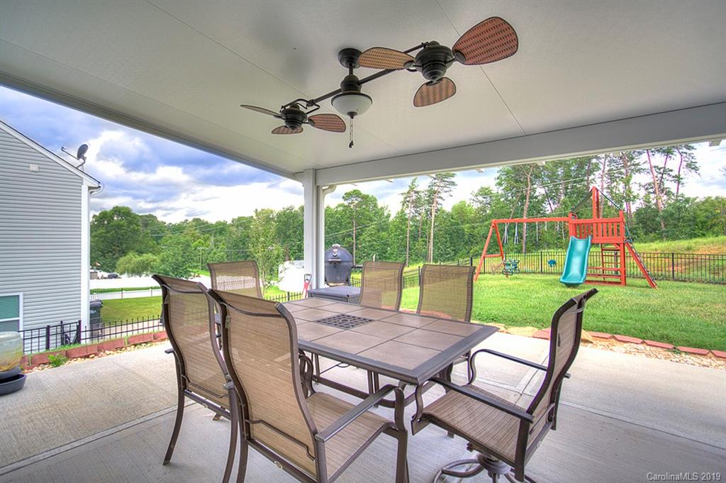 8008 Bryson Road Indian Land, SC 29707 - Photo 4 of 22 a view of a patio with a dining table chairs and a yard