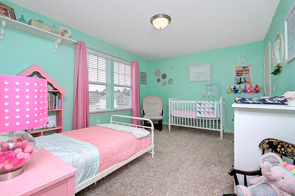8008 Bryson Road Indian Land, SC 29707 - Photo 7 of 22 a bedroom with a bed and a window