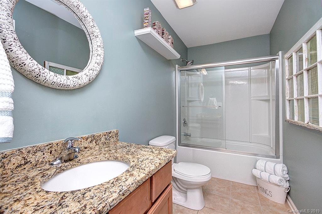8008 Bryson Road Indian Land, SC 29707 - Photo 9 of 22 a bathroom with a granite countertop toilet and a sink