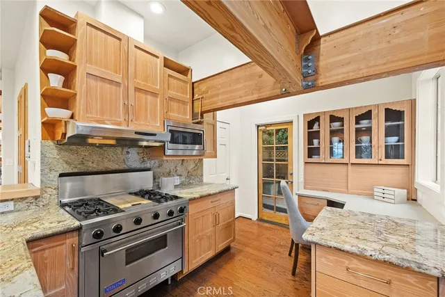 a kitchen with stainless steel appliances granite countertop a stove and a refrigerator
