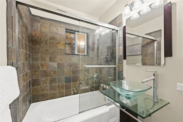 a bathroom with a sink a mirror and a shower