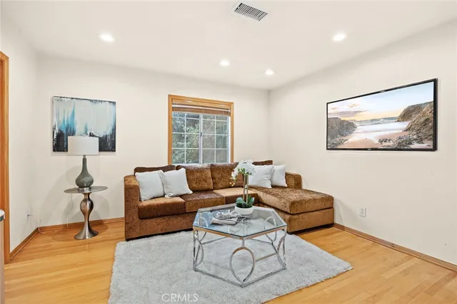 a living room with furniture a rug and a lamp