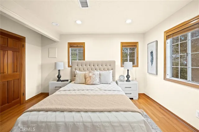 a bedroom with a large bed and a window