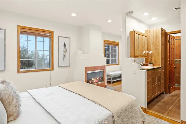 a bedroom with a bed and a large window