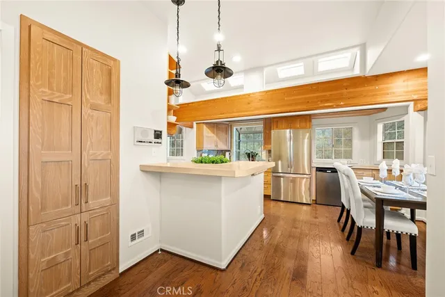 a dining room with furniture and wooden floor
