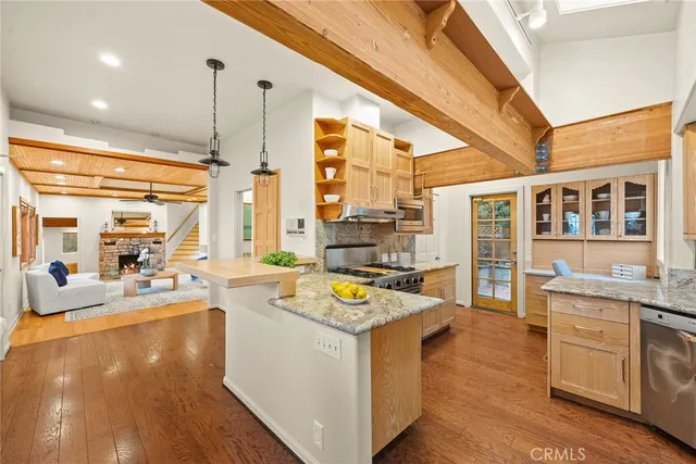 a view of a kitchen with kitchen island a large window in it