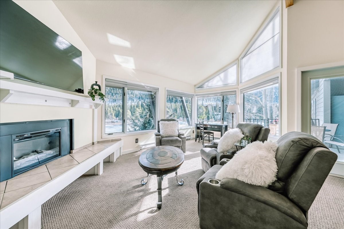 22280 Highway 6, Unit 1716 Keystone, CO 80435 - Photo 1 of 27 a living room with furniture a fireplace and a large window