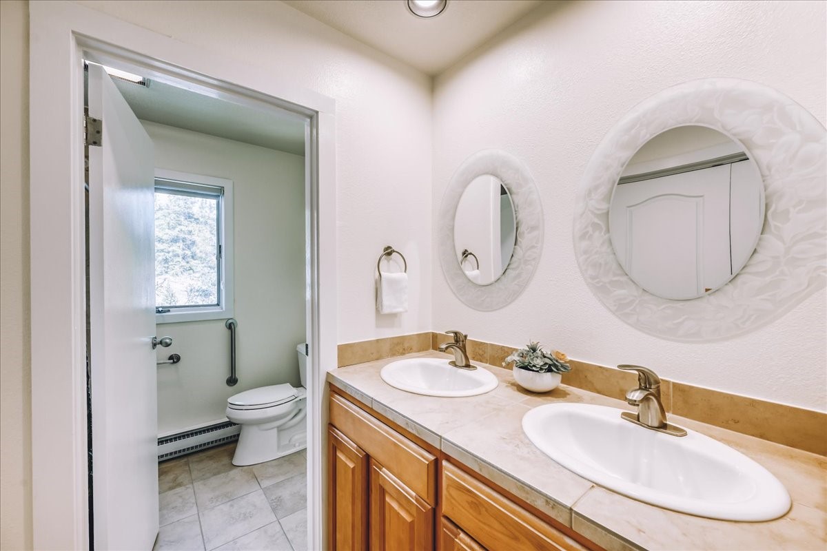 22280 Highway 6, Unit 1716 Keystone, CO 80435 - Photo 11 of 27 a bathroom with a granite countertop toilet a sink and a mirror