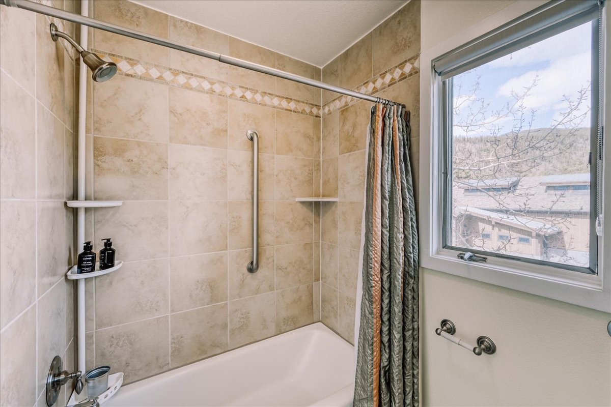 22280 Highway 6, Unit 1716 Keystone, CO 80435 - Photo 12 of 27 a bathroom with a shower and a window