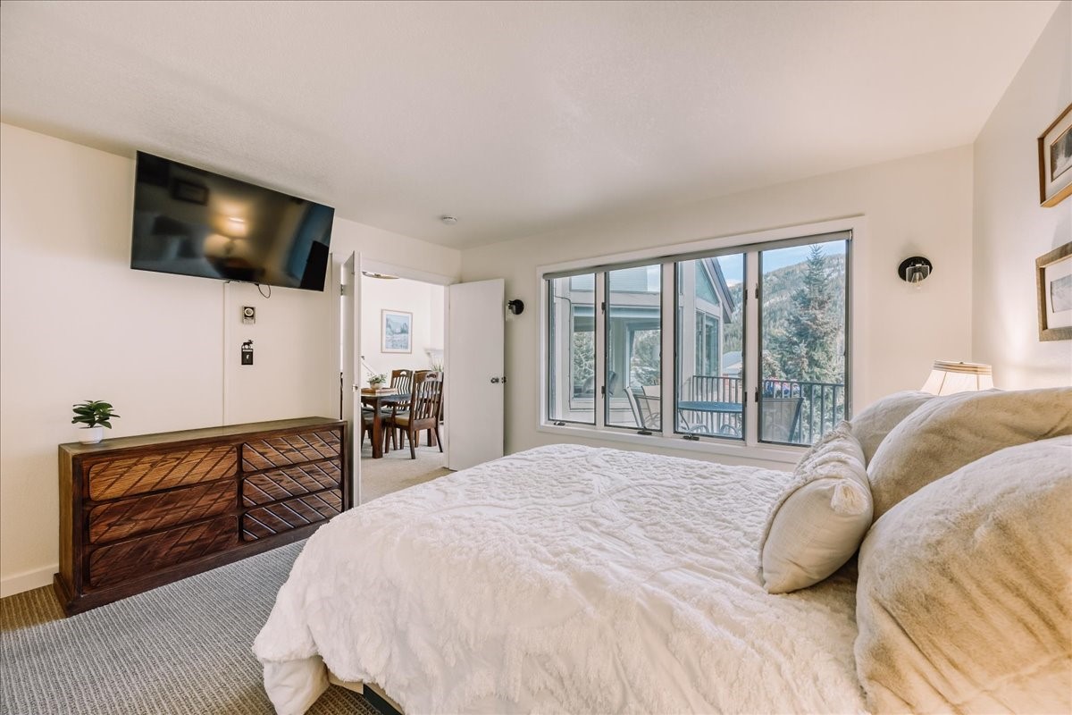 22280 Highway 6, Unit 1716 Keystone, CO 80435 - Photo 15 of 27 a bedroom with a bed and a flat screen tv
