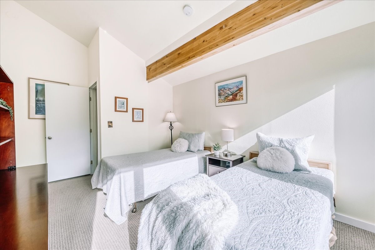 22280 Highway 6, Unit 1716 Keystone, CO 80435 - Photo 19 of 27 a bedroom with a bed and a wooden floor