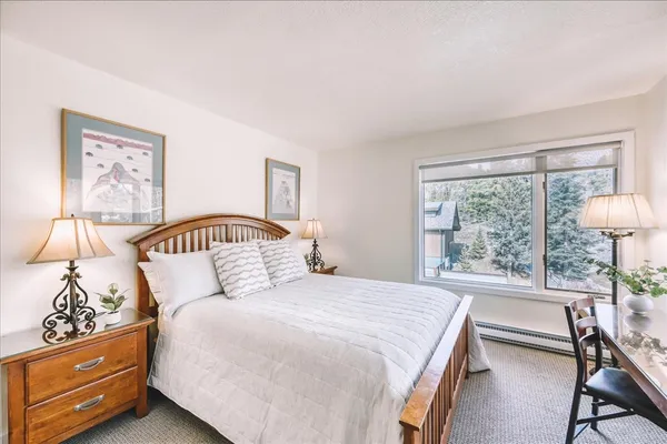 a bedroom with a bed and a table in it