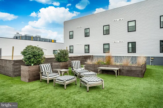 a view of a kitchen with granite countertop a sink and a stove