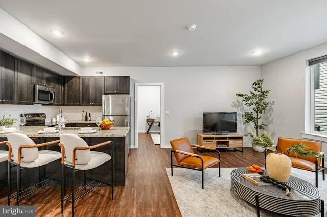 a living room with fireplace furniture and a flat screen tv
