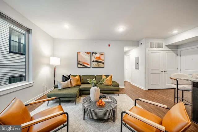 a living room with furniture and a wooden floor