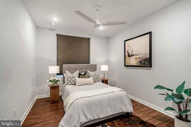 a bedroom with bed and a potted plant