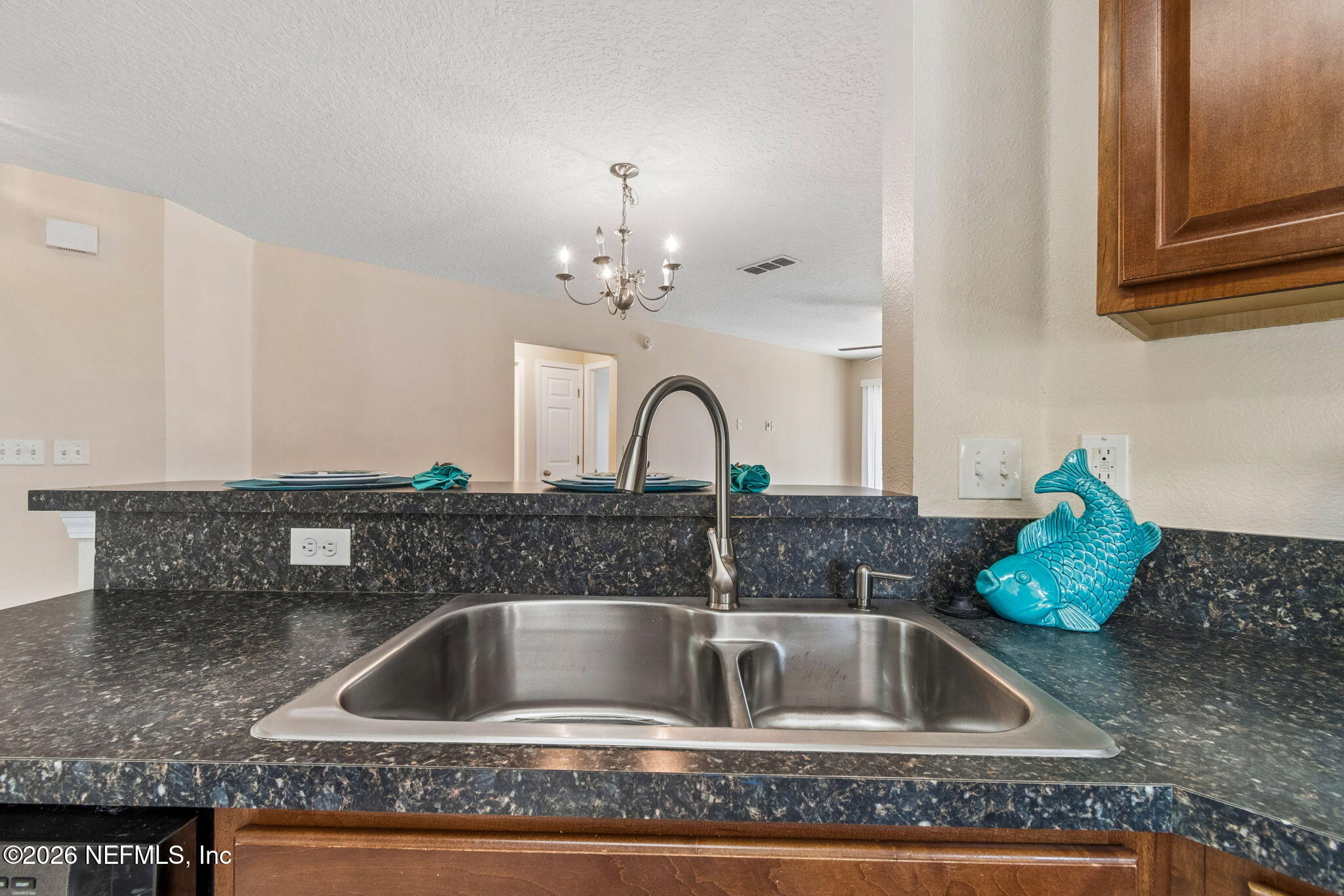73 South Twin Maple Road St. Augustine, FL 32084 - Photo 13 of 59 a kitchen with a sink and chandelier