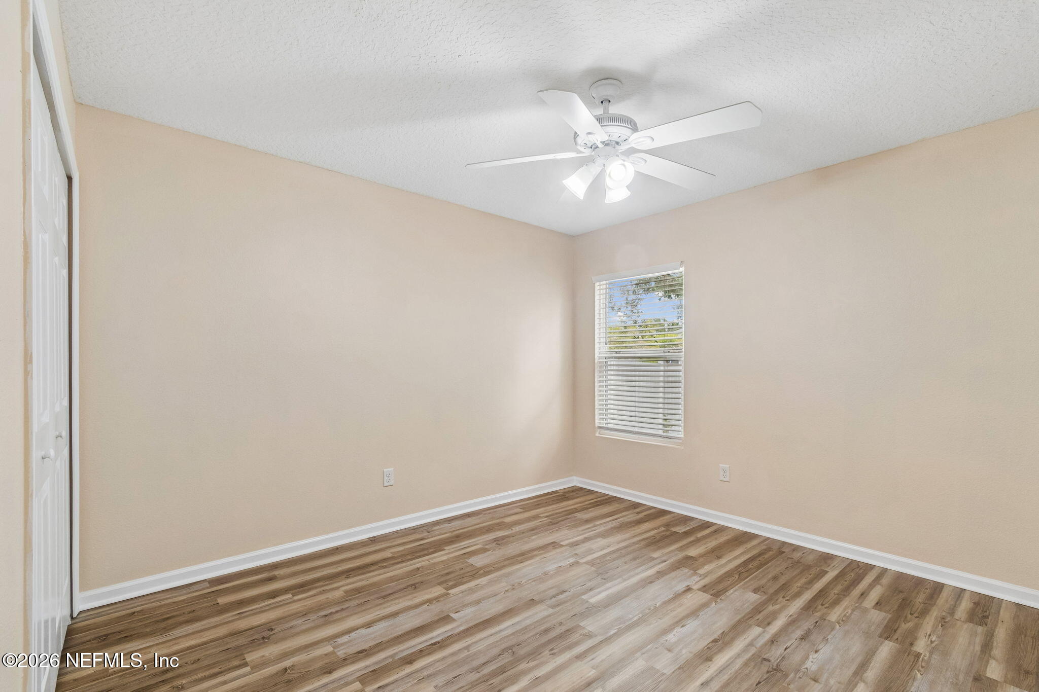 73 South Twin Maple Road St. Augustine, FL 32084 - Photo 25 of 59 an empty room with wooden floor fan and windows