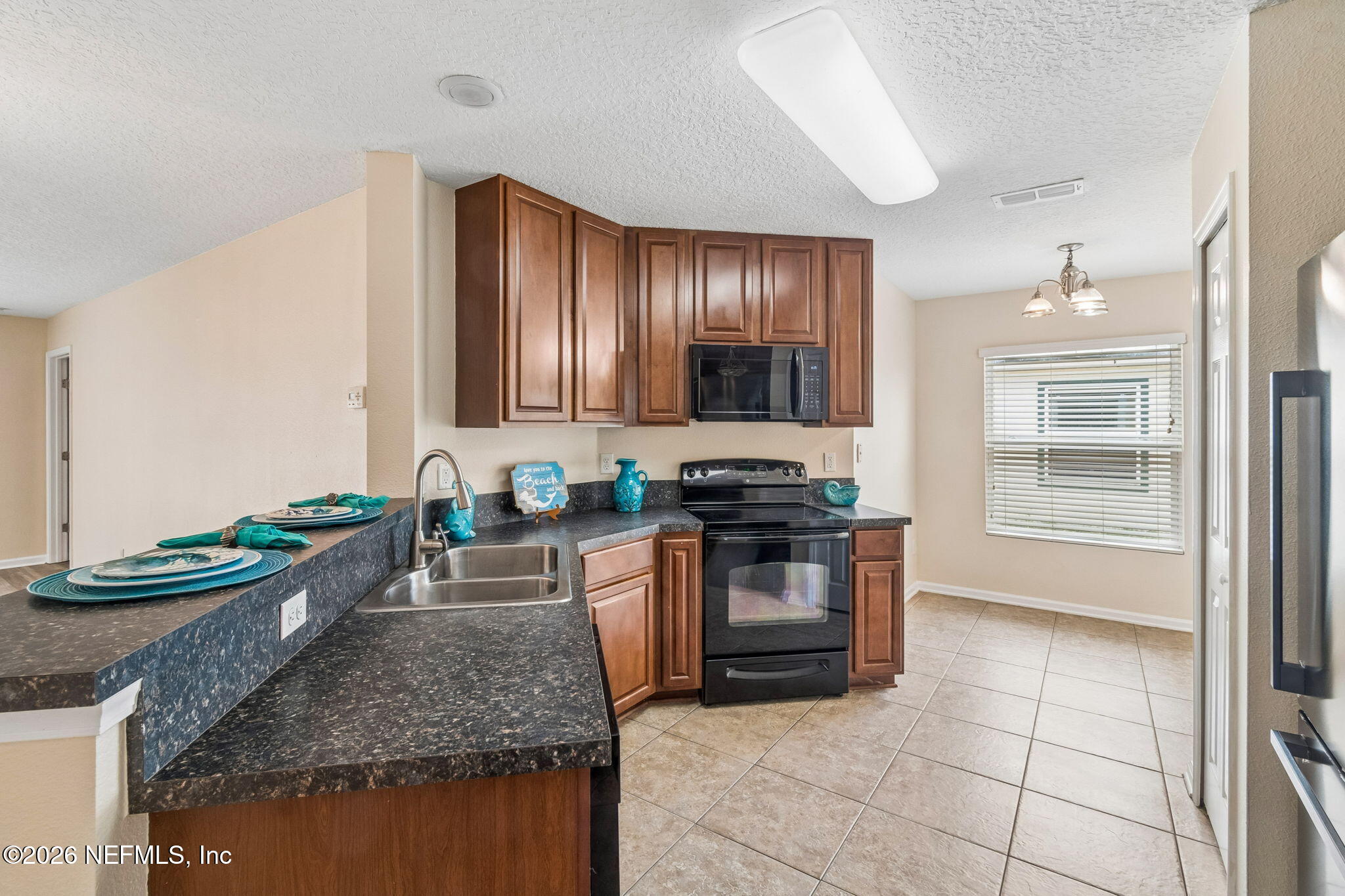 73 South Twin Maple Road St. Augustine, FL 32084 - Photo 9 of 59 a kitchen with stainless steel appliances granite countertop a stove oven and a sink