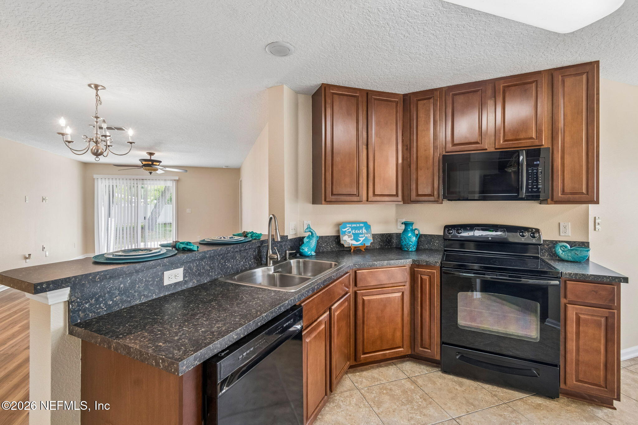73 South Twin Maple Road St. Augustine, FL 32084 - Photo 10 of 59 a kitchen with granite countertop stainless steel appliances a stove sink and cabinets