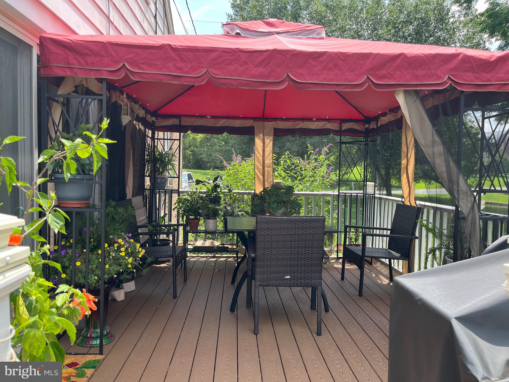 393 Mountain View Road Reading, PA 19607 - Photo 12 of 21 a patio with wooden floor a yard a table and chairs
