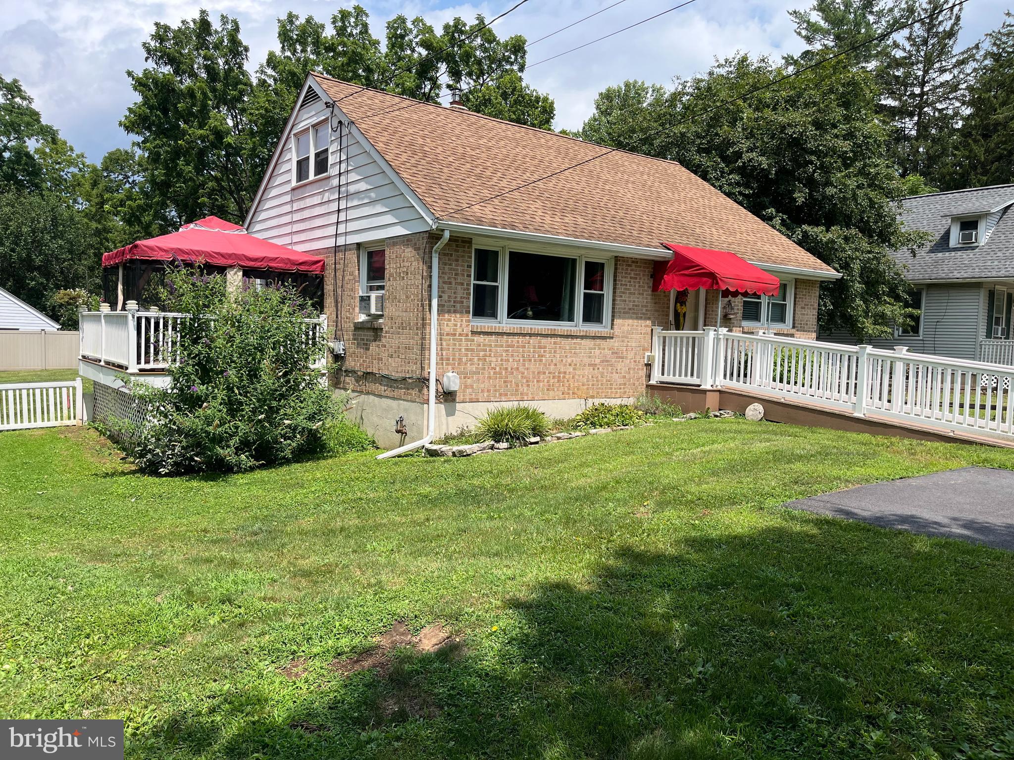 393 Mountain View Road Reading, PA 19607 - Photo 4 of 21 a view of a house with a yard and table and chair under an umbrella