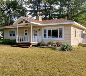 a front view of a house with yard and porch