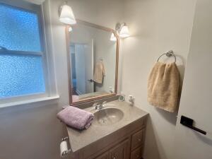 3872 South Hillcrest Road Knox, IN 46534 - Photo 12 of 27 a bathroom with a granite countertop sink and a mirror