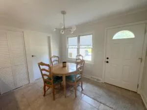 a view of a dining room with furniture and window