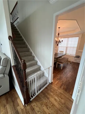 a view of entryway and hall with wooden floor