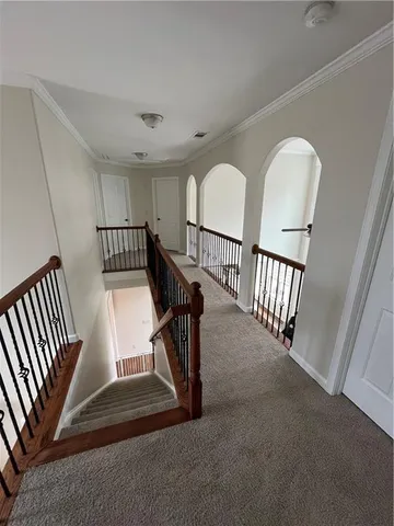 a view of entryway and hall with wooden floor