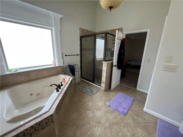a bathroom with a tub sink and mirror
