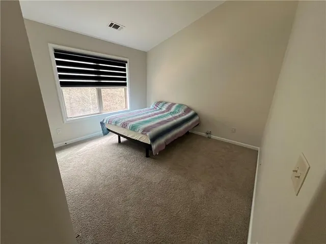 a room with a bed and a window