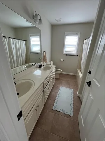 a bathroom with a double vanity sink and mirror