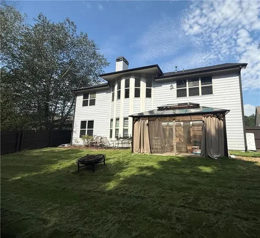 a front view of house with yard slide and outdoor seating