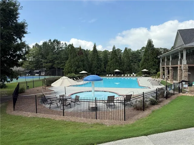 a view of a house with a yard patio and sitting area