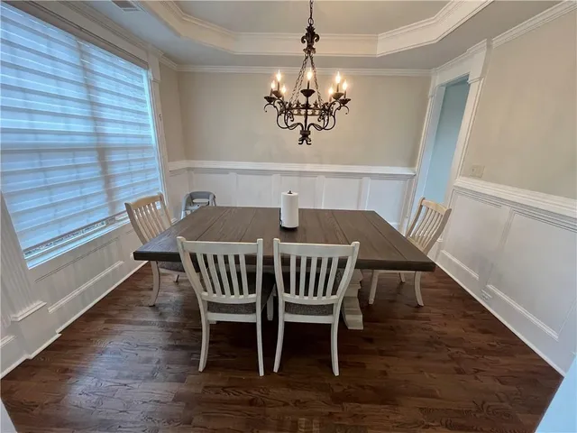 a view of a dining room with furniture wooden floor and chandelier