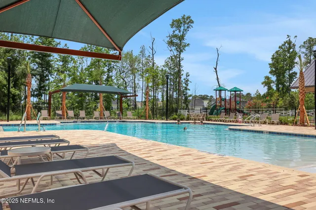 swimming pool view with a seating space