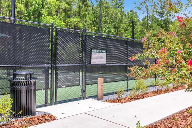 a view of a deck with a large window and wooden fence