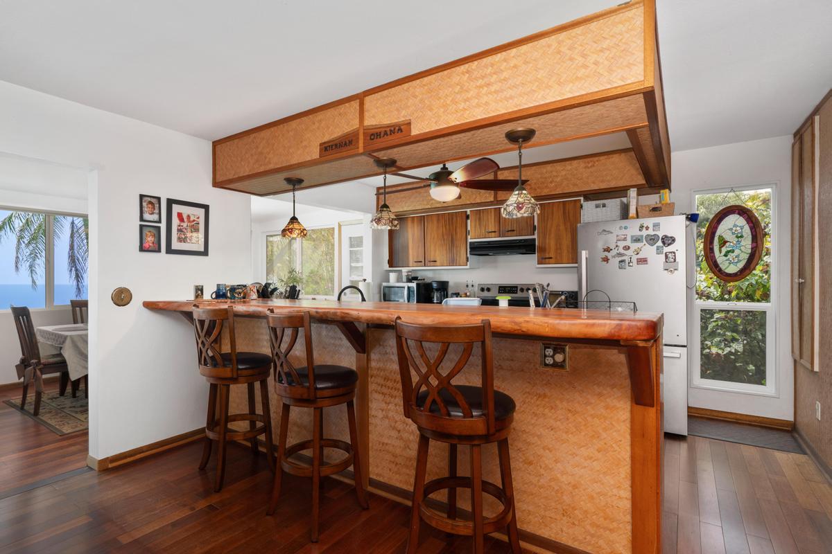 85-4563 Hawaii Belt Road Captain Cook, HI 96704 - Photo 6 of 30 a view of a dining room with furniture and wooden floor