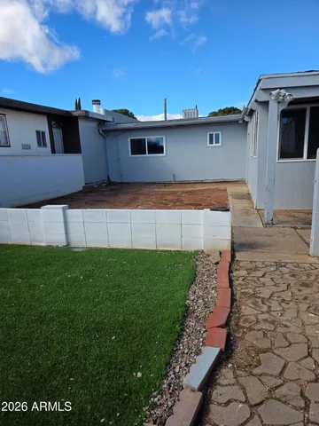 a front view of a house with a garden and yard
