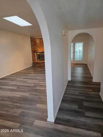 a view of entryway and hall with wooden floor