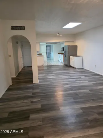 a view of empty room with wooden floor