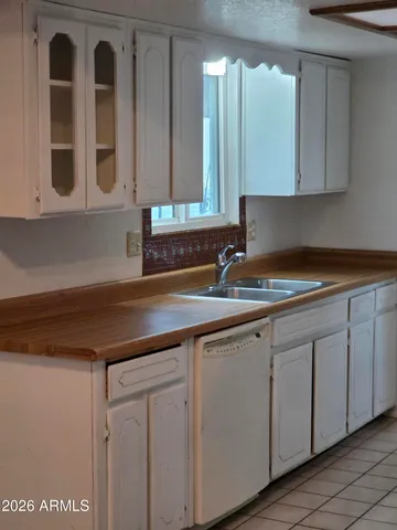 a kitchen with cabinets and sink