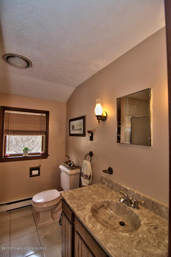 28 Elias Road Moscow, PA 18444 - Photo 19 of 69 a bathroom with a granite countertop sink and a mirror