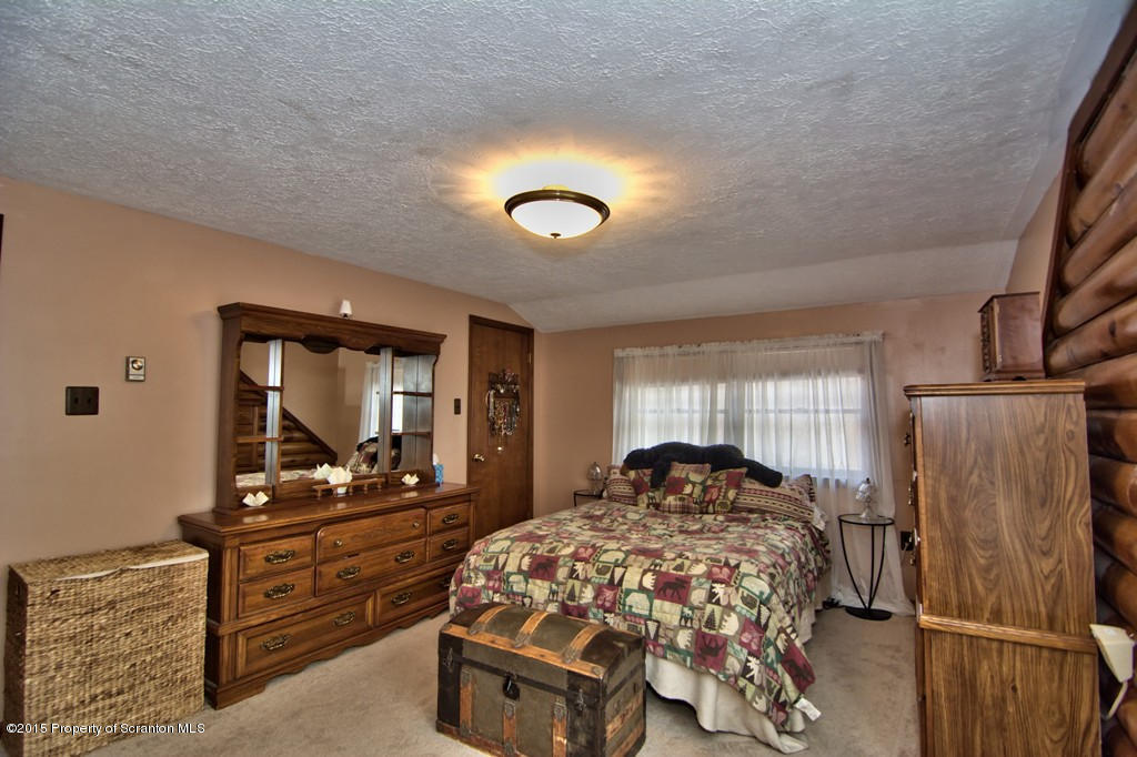 28 Elias Road Moscow, PA 18444 - Photo 23 of 69 a bedroom with a bed and a dresser with mirror