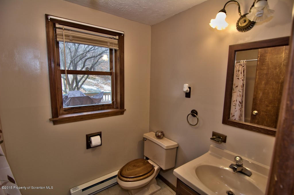 28 Elias Road Moscow, PA 18444 - Photo 10 of 69 a bathroom with a toilet sink and mirror